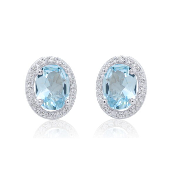 Soikeat hopeakorvakorut, joissa aito vaaleansininen topaasi ja zirkonikehys.