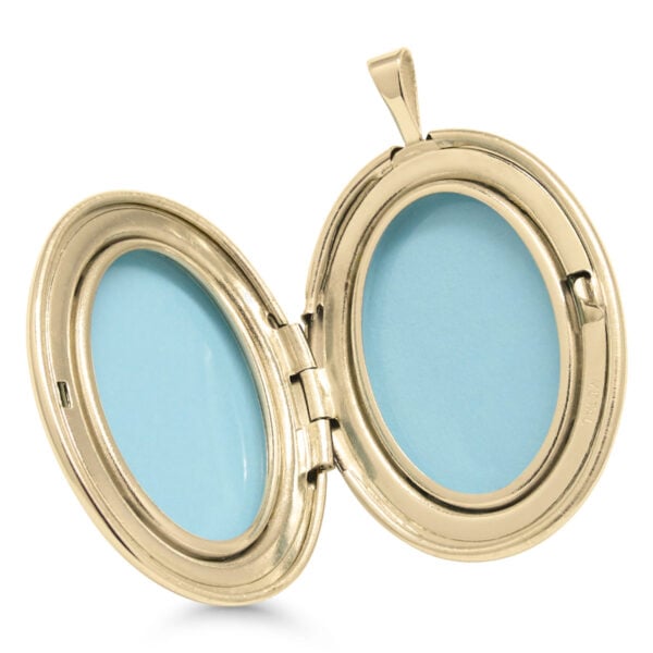 Avattu kullattu hopeamedaljonki kahdelle kuvalle sinisillä sisäkehyksillä