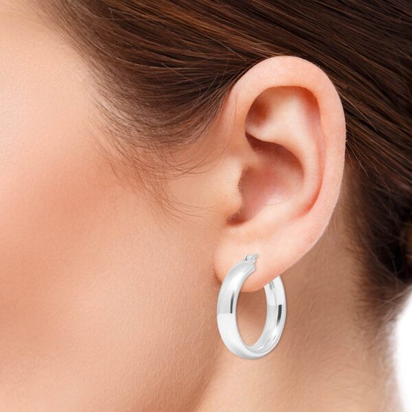 925 hopeiset kiiltävät rengaskorvakorut 25 mm halkaisijalla ja 5 mm leveydellä kuva korvassa